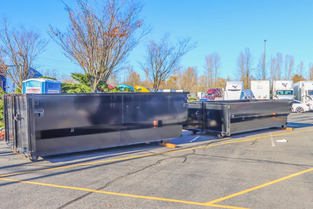 Professional dumpster rental service with roll-off container on residential driveway in Norton Shores